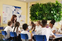 Classroom with living wall around children