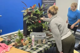 team building participants building a living wall for charity