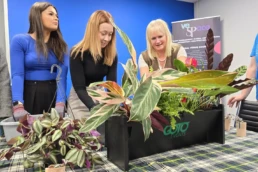 Team arranging flowers for charity team building activity